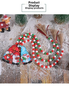 Detail of Christmas gnome ornaments with red white green wood beads and rustic hemp tassels