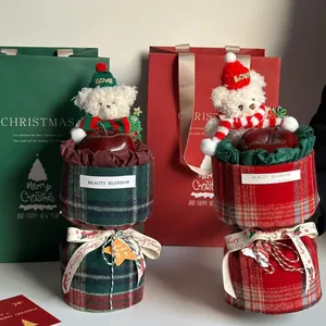 Christmas gift set with plush bear and apple wrapped in red and green checkered plaid fabric