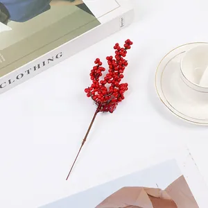 Detailed close-up of vibrant red artificial holly berries for festive home decoration