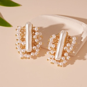 French vintage style earrings with irregular pearls and golden beads on stone tray