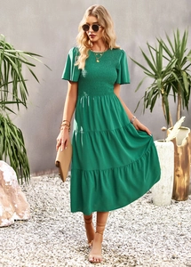 Detail of waist-slimming green maxi dress with shirred design for summer vacation style