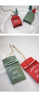 Detail of red and green metal mailbox Christmas ornaments with Merry Christmas lettering