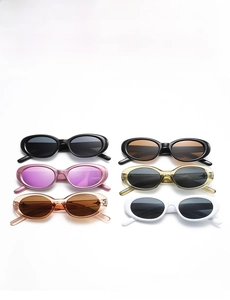 Collection of retro oval sunglasses in black, white, and diverse lens colors in a flat lay