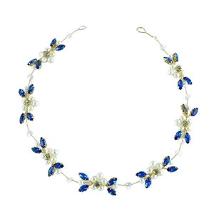 Detail of bridal hair chain featuring blue marquise crystals and white pearls on gold wire
