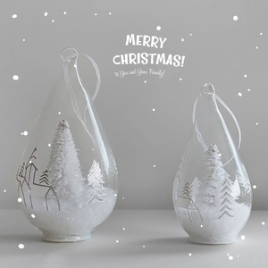 Transparent glass teardrop Christmas ornaments with miniature cedar and snowy houses
