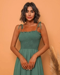 Detail of sage green maxi dress featuring smocked bodice and adjustable tie straps