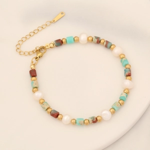 Detail of beaded bracelet with natural stones, white pearls, and gold extension chain