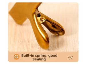 Detail view of gold stainless steel food clip with built-in spring for airtight sealing
