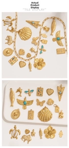 Detailed flat lay of gold-plated stainless steel charms with enamel and rhinestones