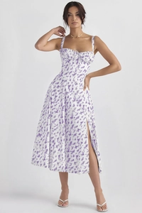 Detail view of the side slit and purple floral pattern on the summer midi dress