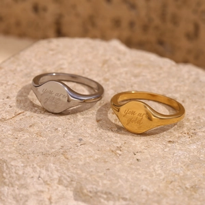 Detail of 18K gold plated stainless steel signet ring with you are gold engraving