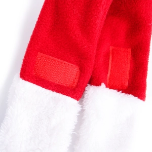 Detail of red fleece Christmas pet cloak featuring white faux fur trim and velcro closure