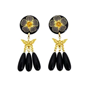 Vintage style drop earrings with gold floral disc, butterfly and black waterdrop charms