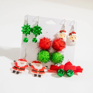 Detail view of a 6-pair Christmas earring set with Santa, bells, and plush pom-poms