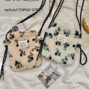 Detailed view of plush lamb wool crossbody bags featuring cute floral patterns on soft fabric