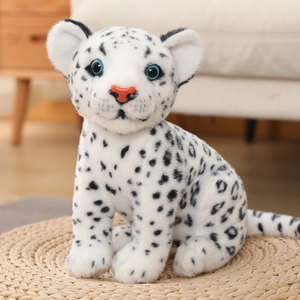 Close-up of a plush snow leopard doll with realistic black spots and bright blue eyes