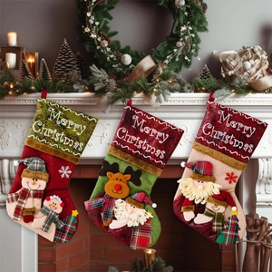 Detailed view of 3D Santa, reindeer, and snowman Christmas stockings on a mantel
