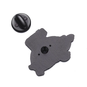 Detailed view of turtle badge back with black metal texture and rubber clutch