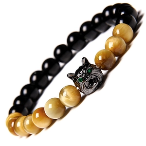 Macro view of natural tiger eye beads and dark metal wolf head charm on beaded bracelet