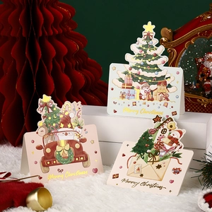 Three 3D pop-up Christmas greeting cards with gold foil patterns on festive background