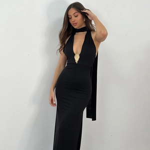 Detail of the elegant gold relief metal buckle on the deep V-neck black halter dress
