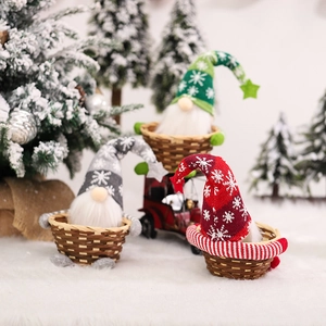Three-piece knitted Christmas gnome candy baskets with bamboo weave on snowy background