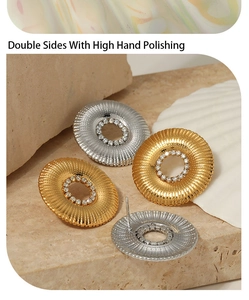 Close-up of gold and silver sunburst earrings with high hand polishing and CZ inlay