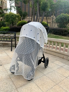 Detail of baby stroller sunshade and mosquito net with whale pattern cotton gauze fabric