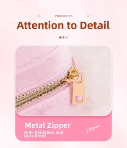 Detail of pink jewelry box featuring oxidation-resistant gold metal zipper and hardware