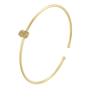 Macro shot of gold letter S bracelet featuring crystal pavé inlay on an open cuff
