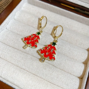 Close-up of gold Christmas tree earrings with red green enamel and sparkling rhinestones