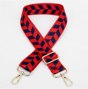 Detail of red and navy herringbone jacquard strap with gold metal lobster clasps