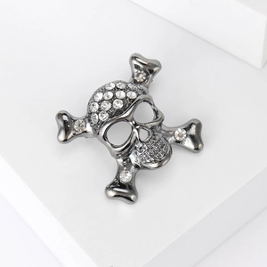 Macro shot of punk style skull and crossbones brooch with sparkling rhinestones detail