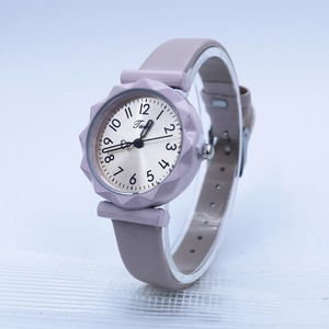 Detail of lilac silicone strap and sunflower-shaped bezel on minimalist quartz watch