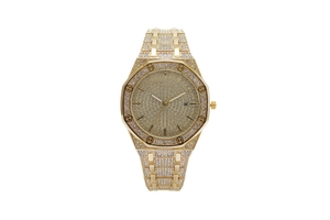 Detail of luxurious gold octagonal watch featuring full diamond setting and date window