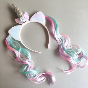 Close-up of unicorn headband with silver horn, pink wings and colorful hair extension