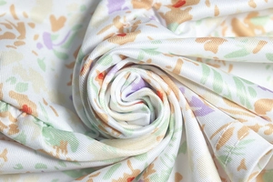 Detailed macro view of colorful floral fabric with soft pleats and smooth texture