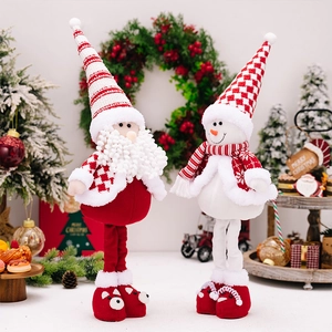 Detail of plush standing Santa and snowman dolls with red white striped hats and legs
