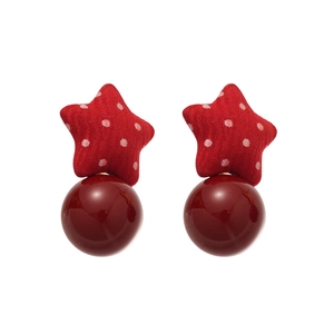 Red fabric star earrings with white polka dots and burgundy pearl pendants on white background