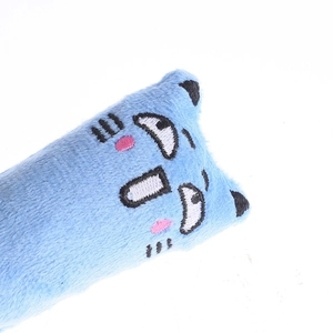 Close-up detail of blue plush catnip toy with cute embroidered cartoon expression