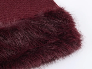 Detailed macro view of dark burgundy knit fabric joined with plush faux fur material