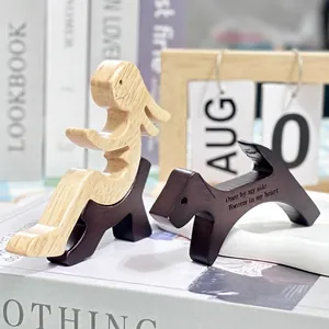 Handcrafted wooden sculpture of human and dog cuddling with emotional engraving