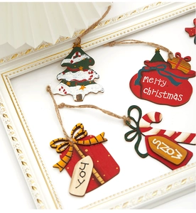 Detailed view of 7cm wooden Christmas ornaments with rustic twine on a white frame