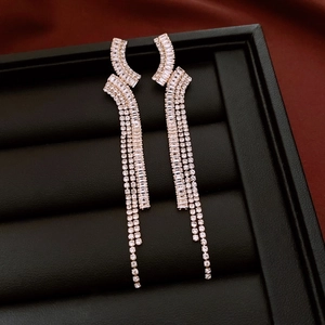 Macro detail of luxury geometric silver fringe earrings with shimmering zircon crystals
