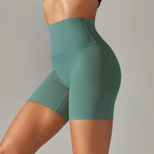 Detail view of high-waist slimming yoga shorts in dark green with seamless finish