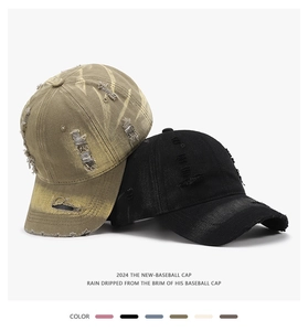 Close-up of washed distressed baseball caps with ripped holes and vintage texture detail