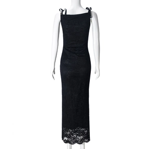 Detailed back view of a black lace maxi dress featuring backless tie-up bow and floral hem