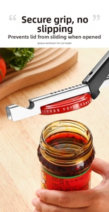 Detail showing the space aluminum jar opener gripping a cap on a wooden kitchen counter