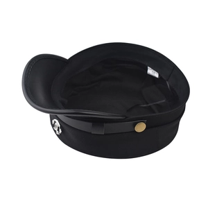 Detail view of the black fiddler cap showing interior size tag and metallic logo accent