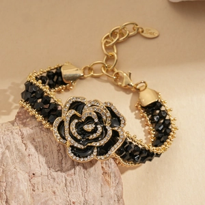 Close-up of a dark rose choker with black beads and sparkling crystal embellishments